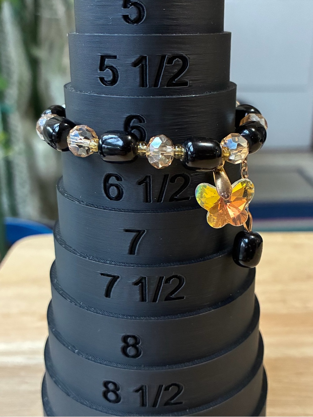 Black and Gold Beaded Stretch Bracelet with Iridescent Flower Charm - Picture 4 of 9